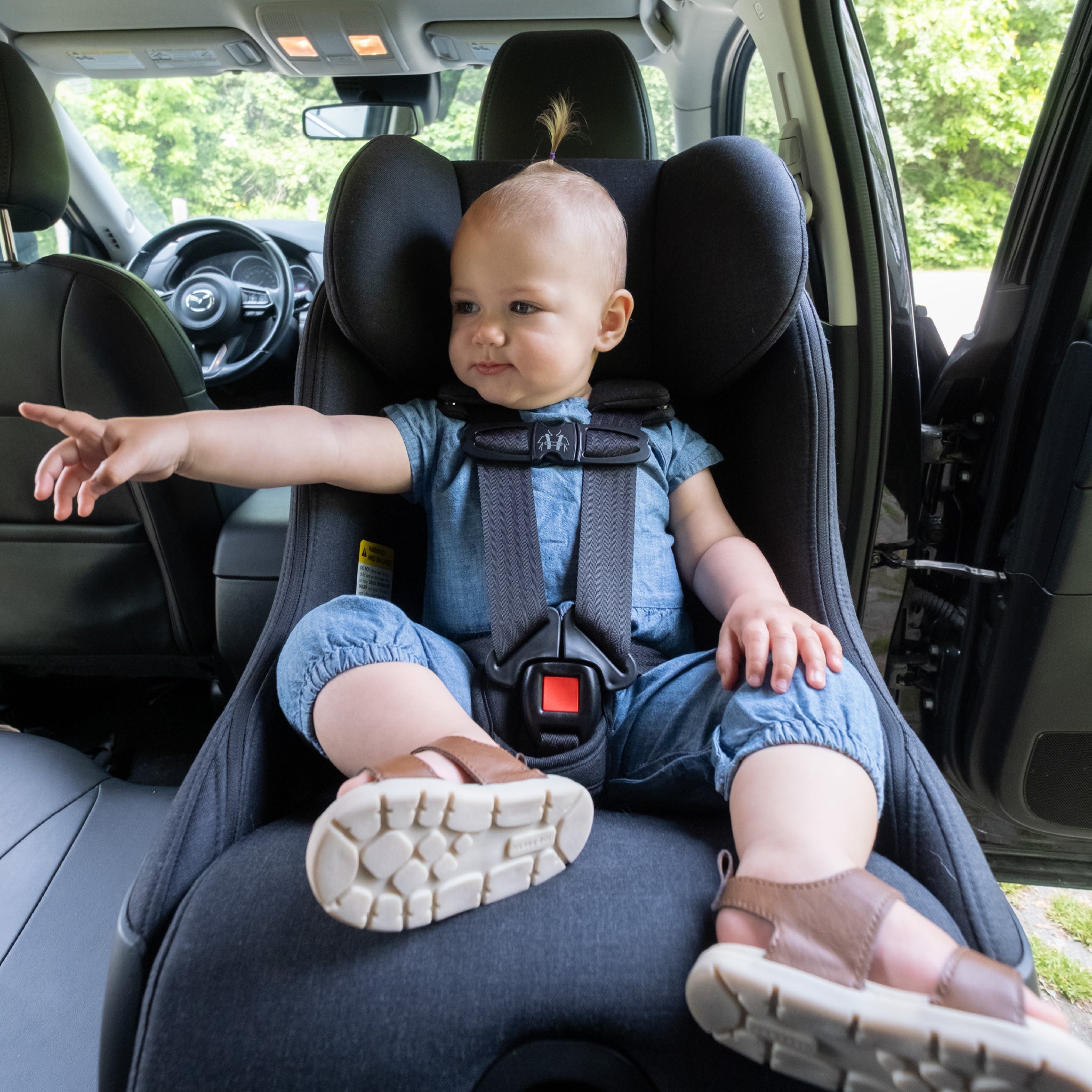 Child secured in their Clek Foonf car seat all-groups
