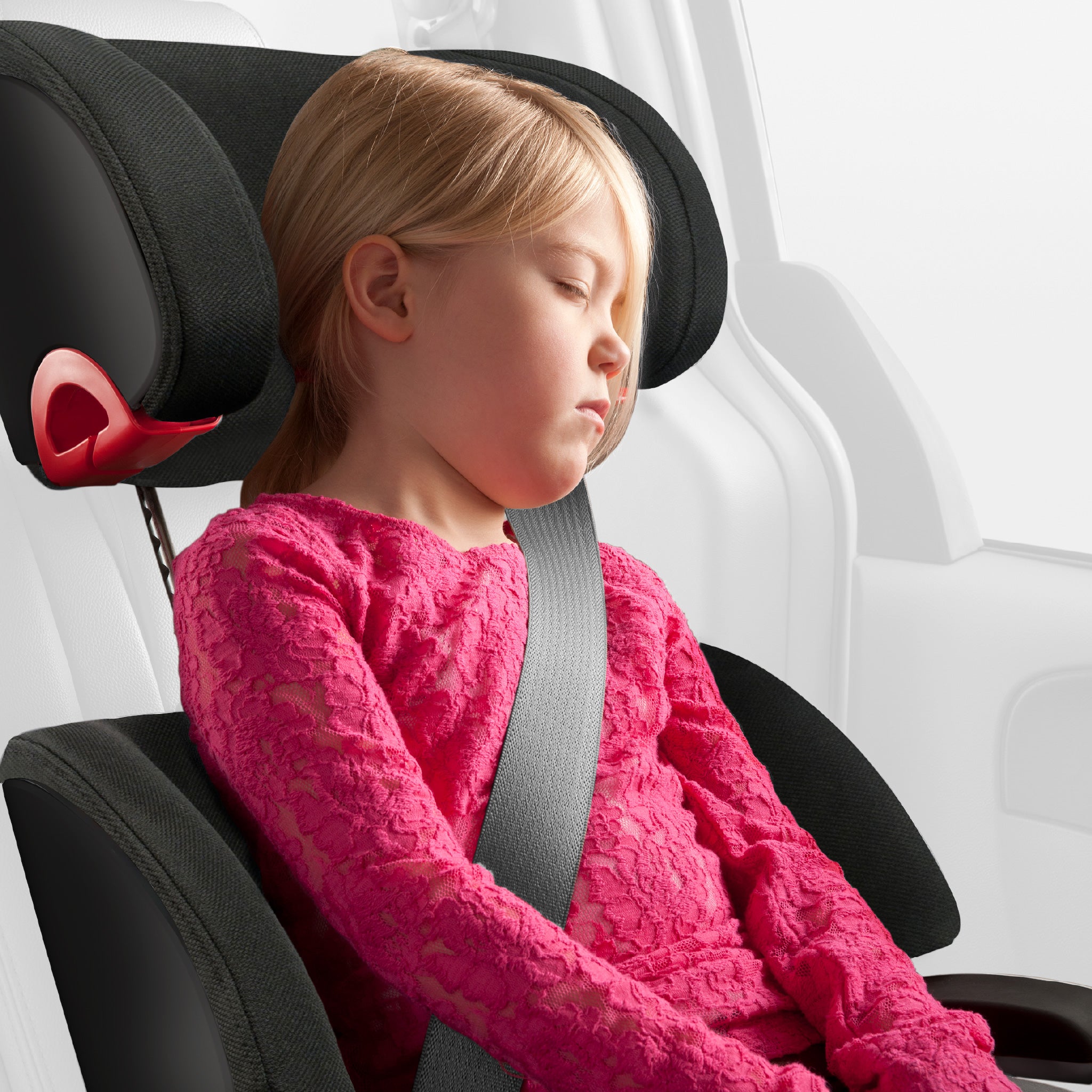 Child in a car seat with a pink sweater, inside a vehicle. all-groups