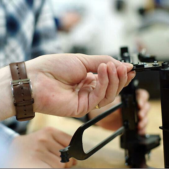 Engineers working on a Clek car seat component.