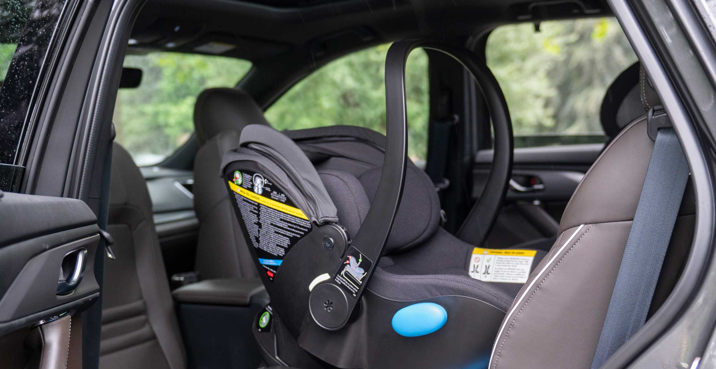 Clek Liing Infant Car Seat in railroad flame-retardant free fabric installed in a vehicle