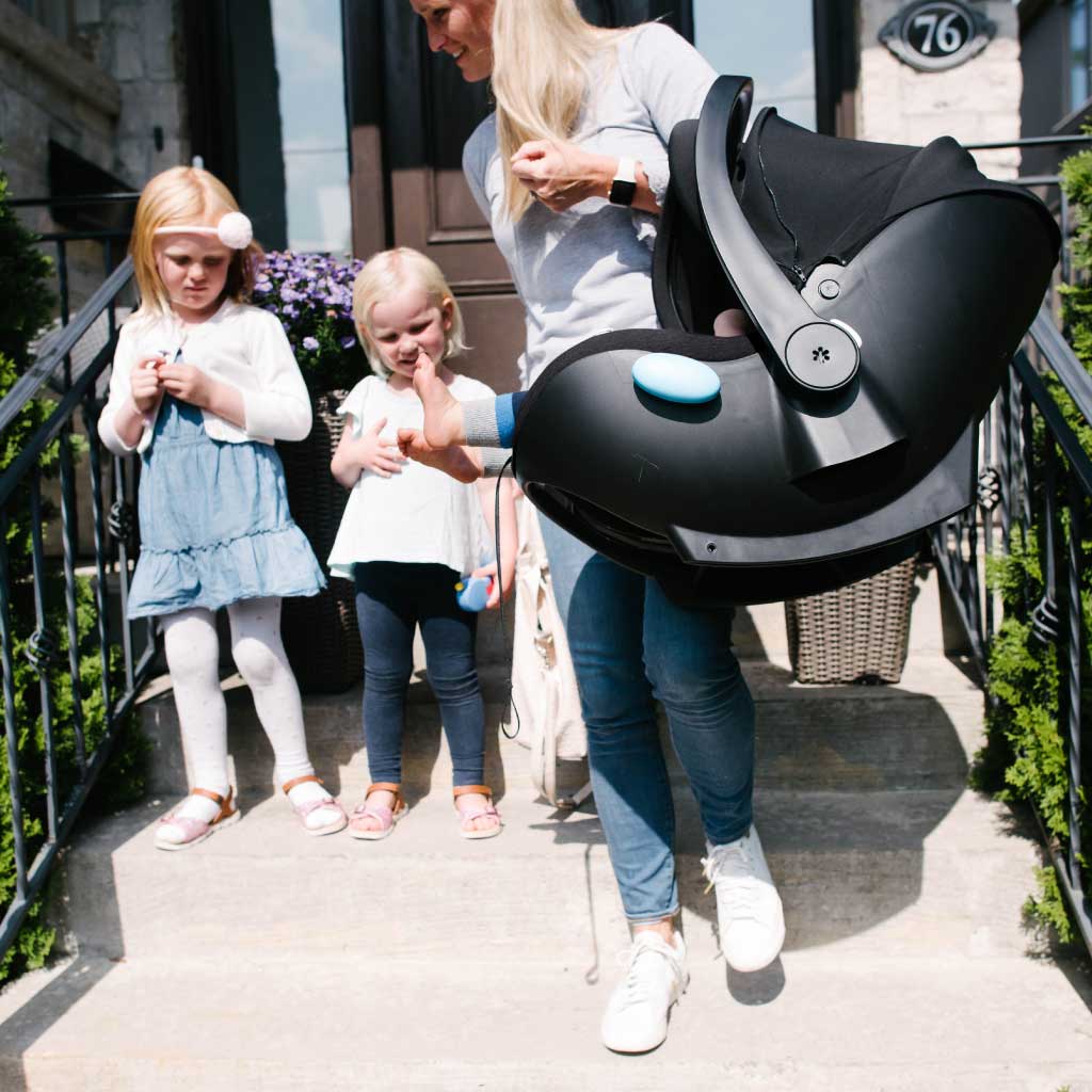 Mom carrying her baby in a Clek Liingo infant car seat