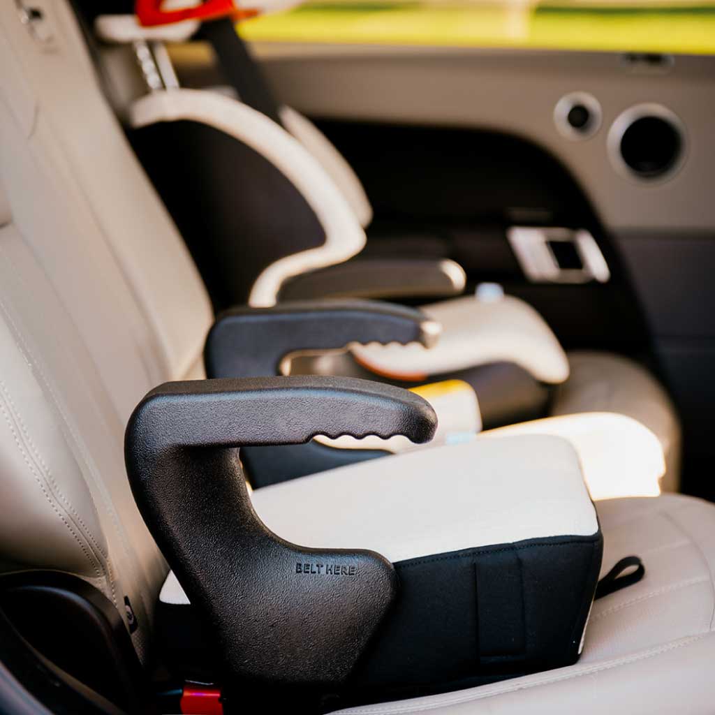 Clek Olli booster seat in Marshmallow fabric installed in a Range Rover SUV