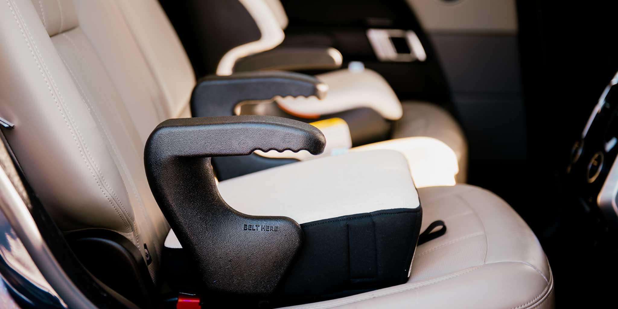 Clek Olli booster seat in Marshmallow fabric installed in a Range Rover SUV